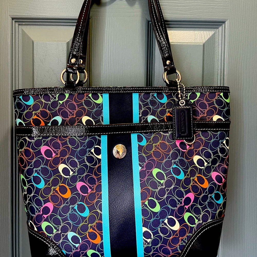 Navy Coach shoulder bag with multi-color C’s. Accompanying cosmetics case.
